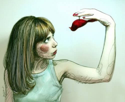 Kvinne holder rød fugl