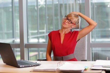 Kvinne på kontoret lindrer nakkesmerter