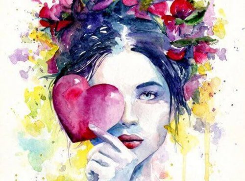 Kvinne holder et hjerte foran øyet