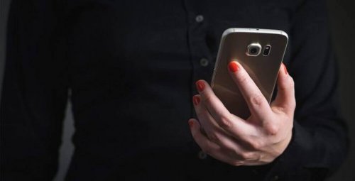 kvinne holder mobiltelefon - null kontakt