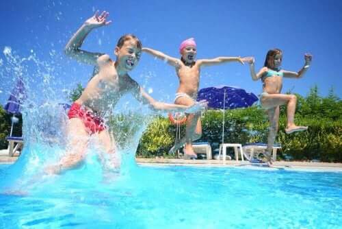 Tre barn som hopper i et basseng, de ser ikke ut til å være overbelastet med aktiviteter.