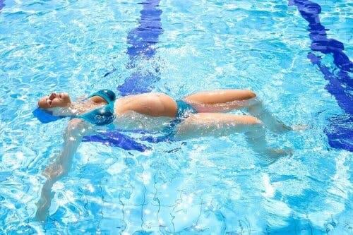 En gravid kvinne svømmer