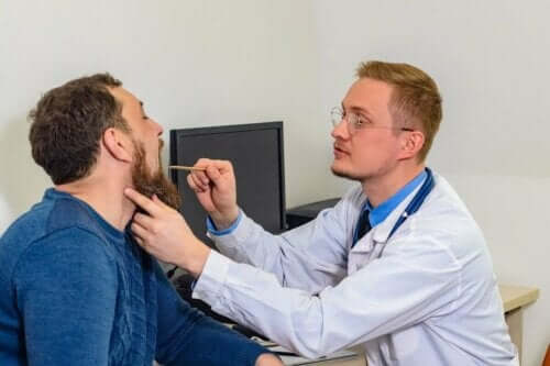 En mann som får stemmebåndene sjekket av en lege.