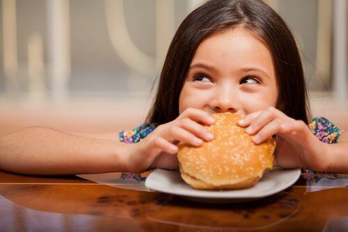 Jente som spiser burger.